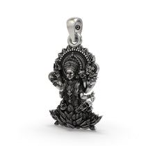 Close-up detail of the multi-armed goddess and floral halo on this sterling silver Lakshmi Maa pendant.