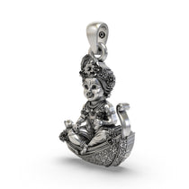 Close-up detail of the handcrafted 925 sterling silver Laddu Gopal pendant showing the peacock crown.