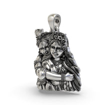 Close-up of the sterling silver Radha Krishna pendant highlighting expressive faces and floral crowns.
