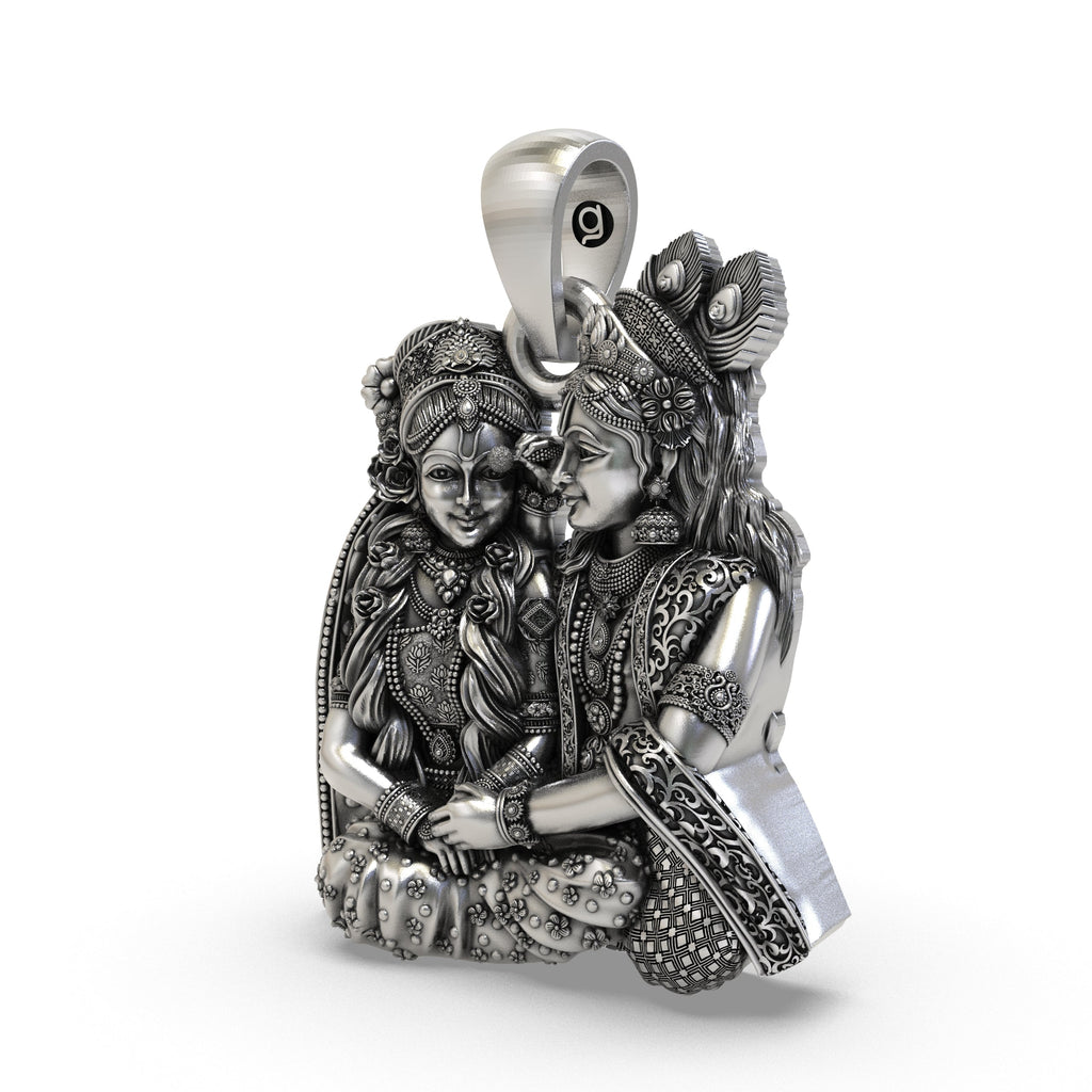 Close-up detailing of the handcrafted silver Radha Krishna pendant showing floral crown and jewels.