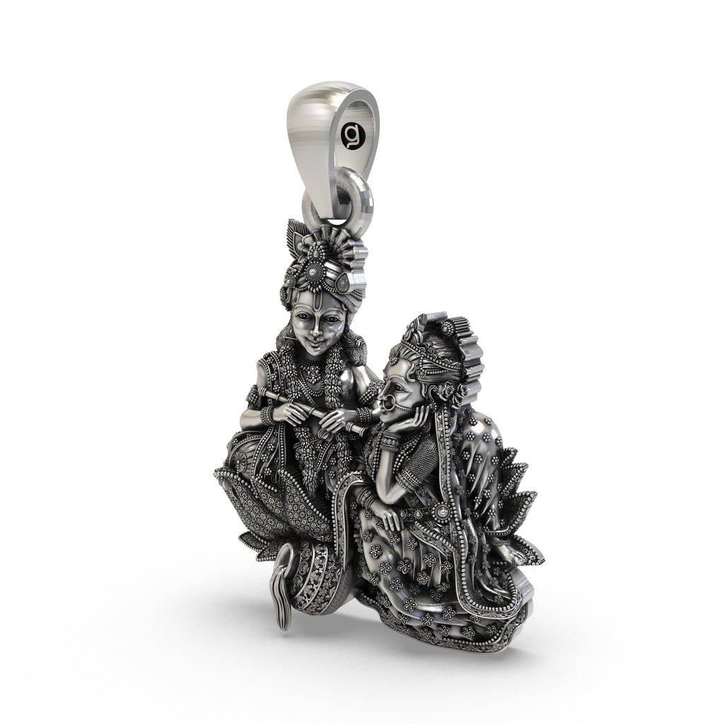 Close-up detail of handcrafted 925 silver Radha Krishna pendant showing intricate peacock motifs.