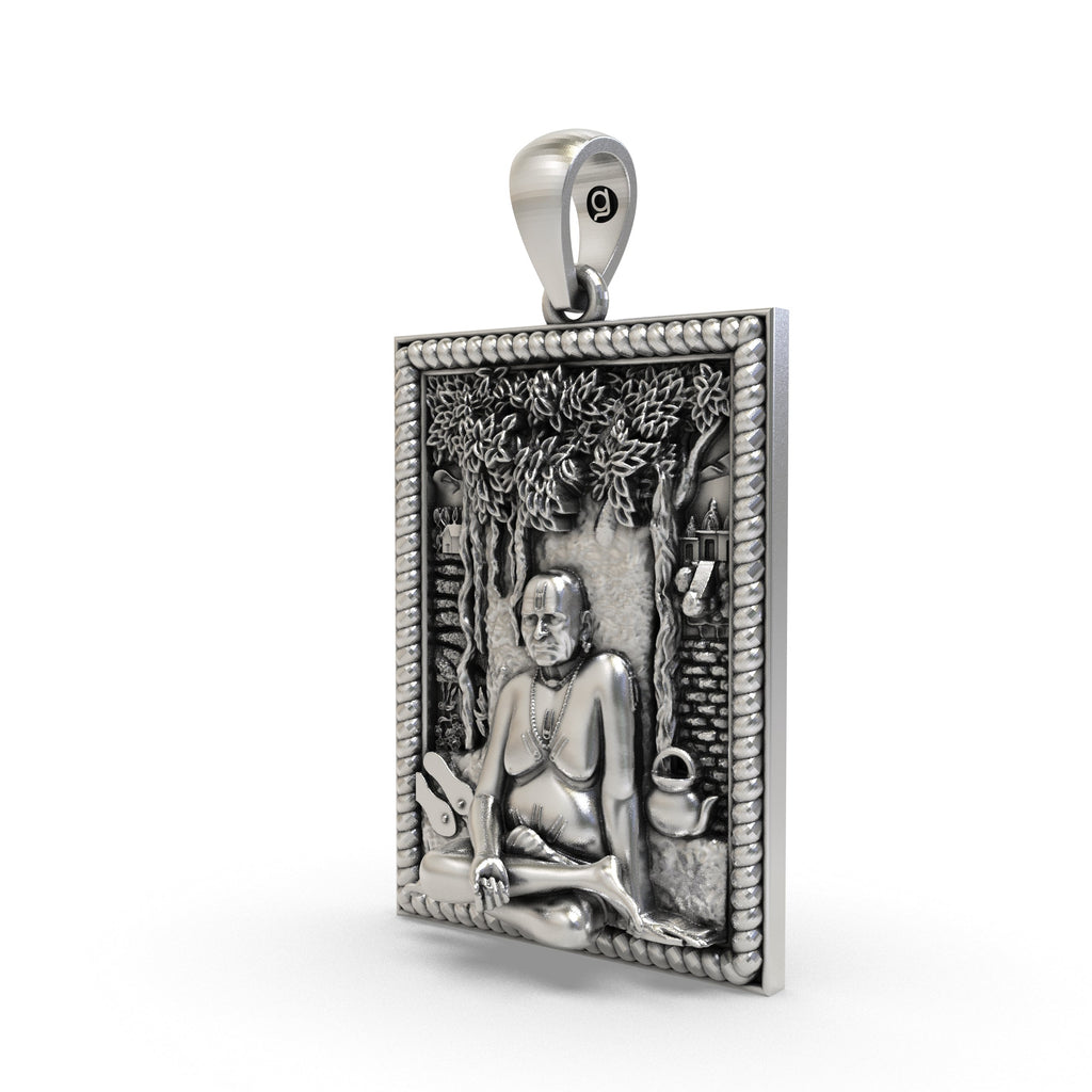 Close-up of the spiritual Swami Samarth Maharaj silver locket showing divine features.