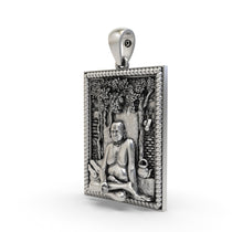 Close-up of the spiritual Swami Samarth Maharaj silver locket showing divine features.