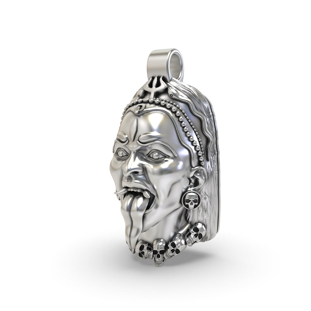 Angled view of the sterling silver Kali Maa face pendant highlighting the intricate details of the goddess's trident.