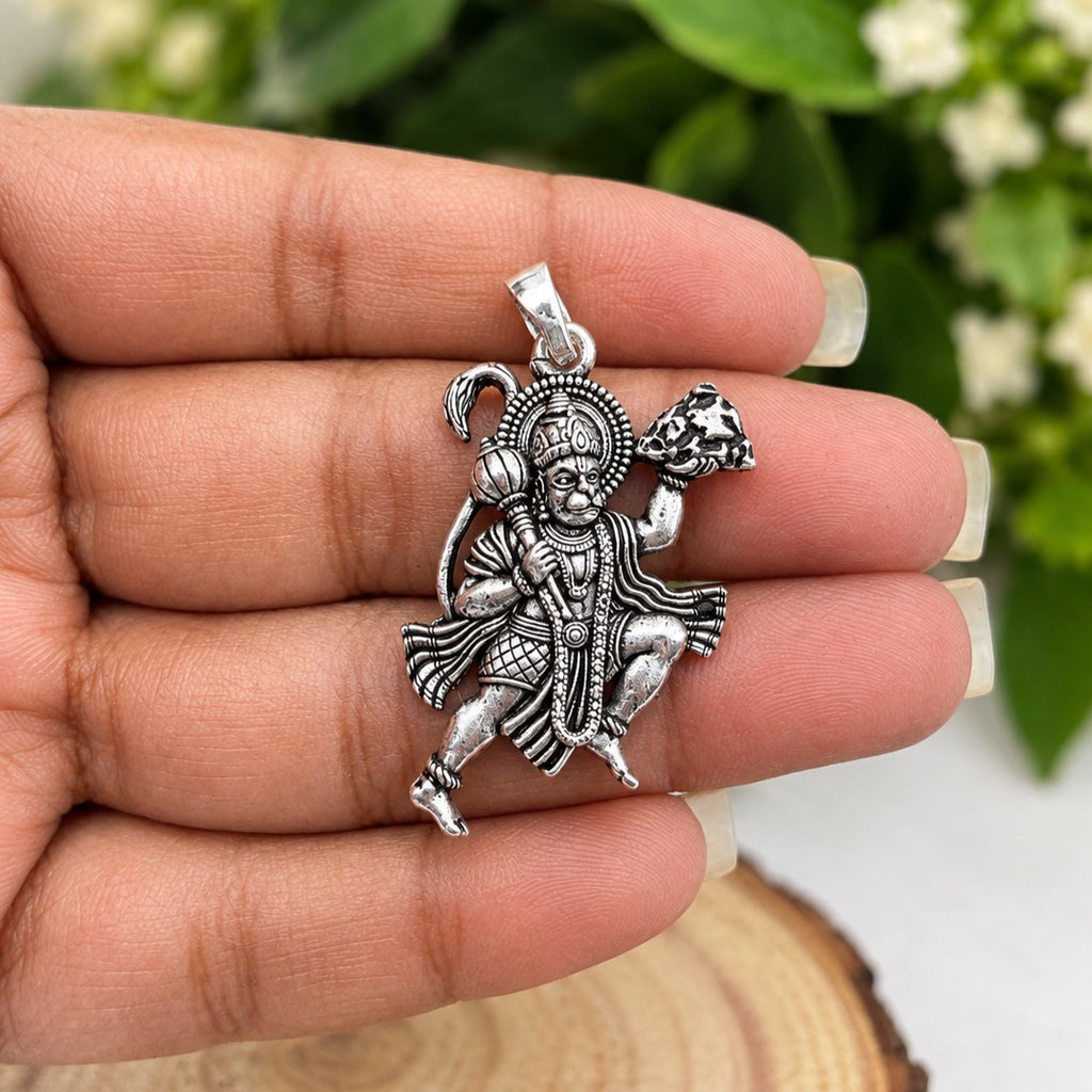 Hanuman Pendant in Hand Among Foliage-crop.jpg