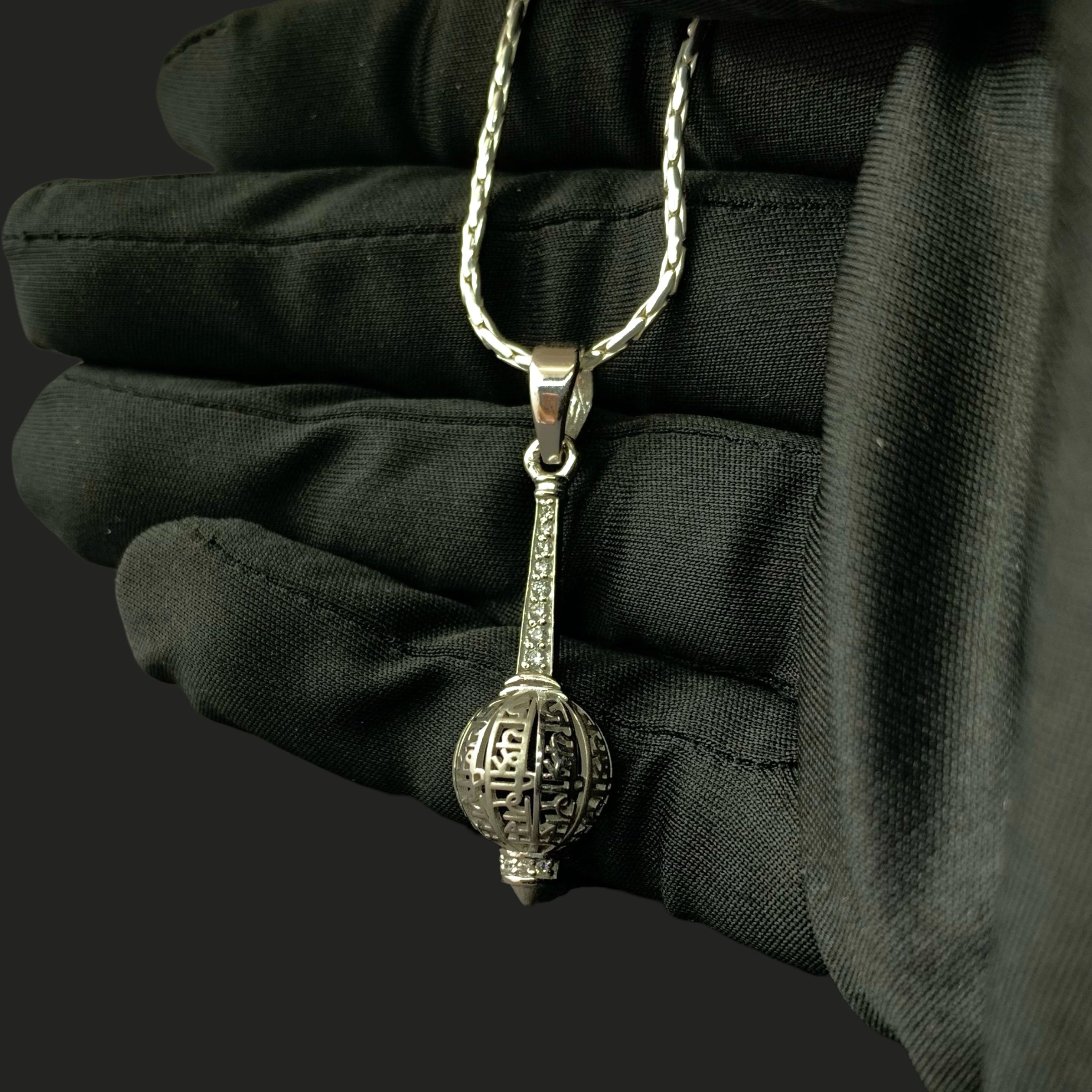Beautifully crafted Bajrangbali gada silver pendant shown resting gently on a flat surface.