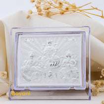 A front view of the 999 pure silver stand featuring detailed idols of Ganesha, Lakshmi, and Saraswati together.