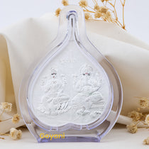 Front view of the 999 pure silver Ganesha and Lakshmi Maa idol seated on an intricately designed pan leaf stand.