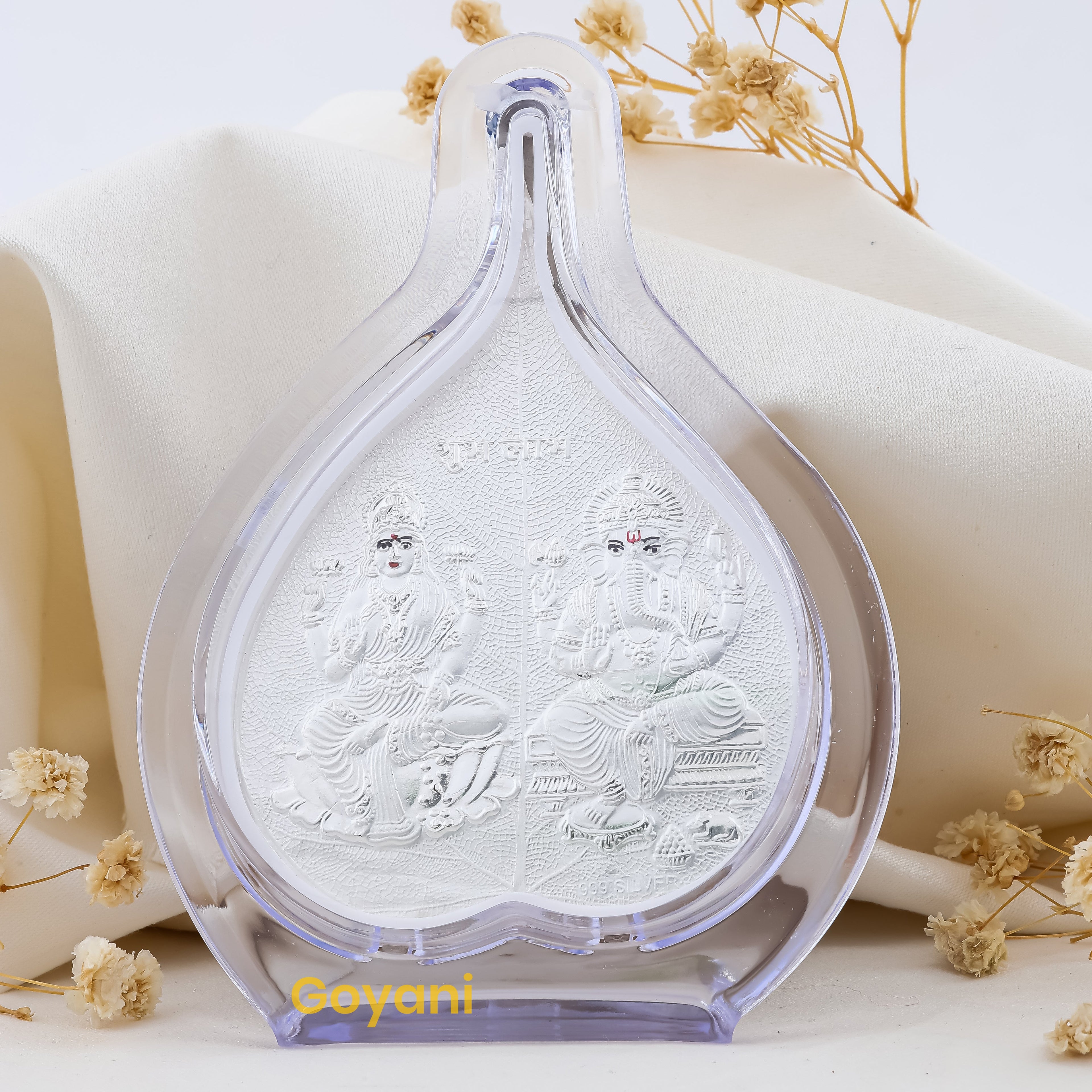 Front view of the 999 pure silver Ganesha and Lakshmi Maa idol seated on an intricately designed pan leaf stand.