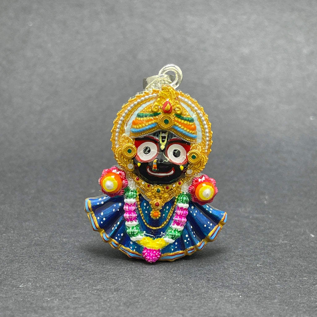 Angled side view of the handmade 925 silver Jagannath pendant, highlighting its polished silver finish.