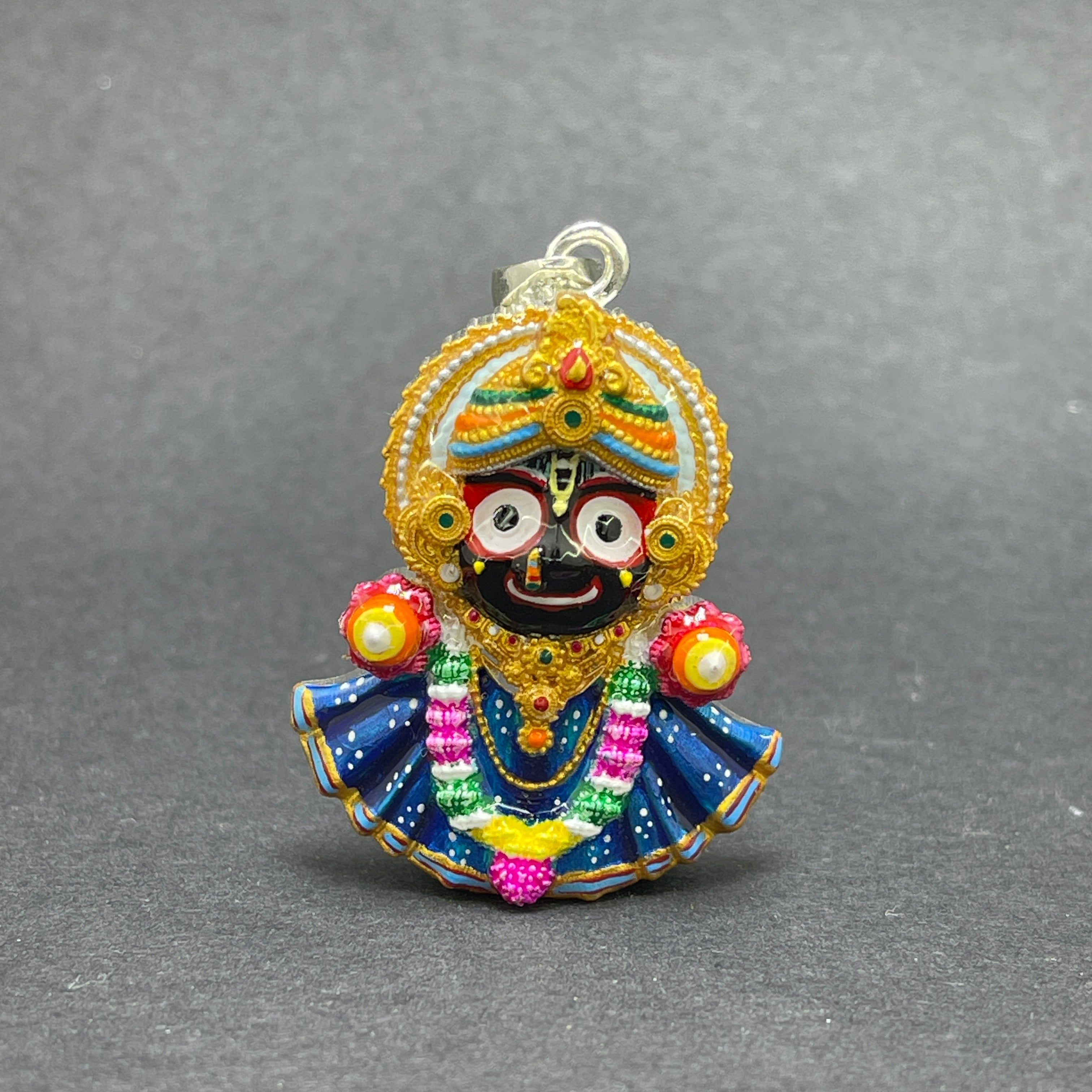 Angled side view of the handmade 925 silver Jagannath pendant, highlighting its polished silver finish.