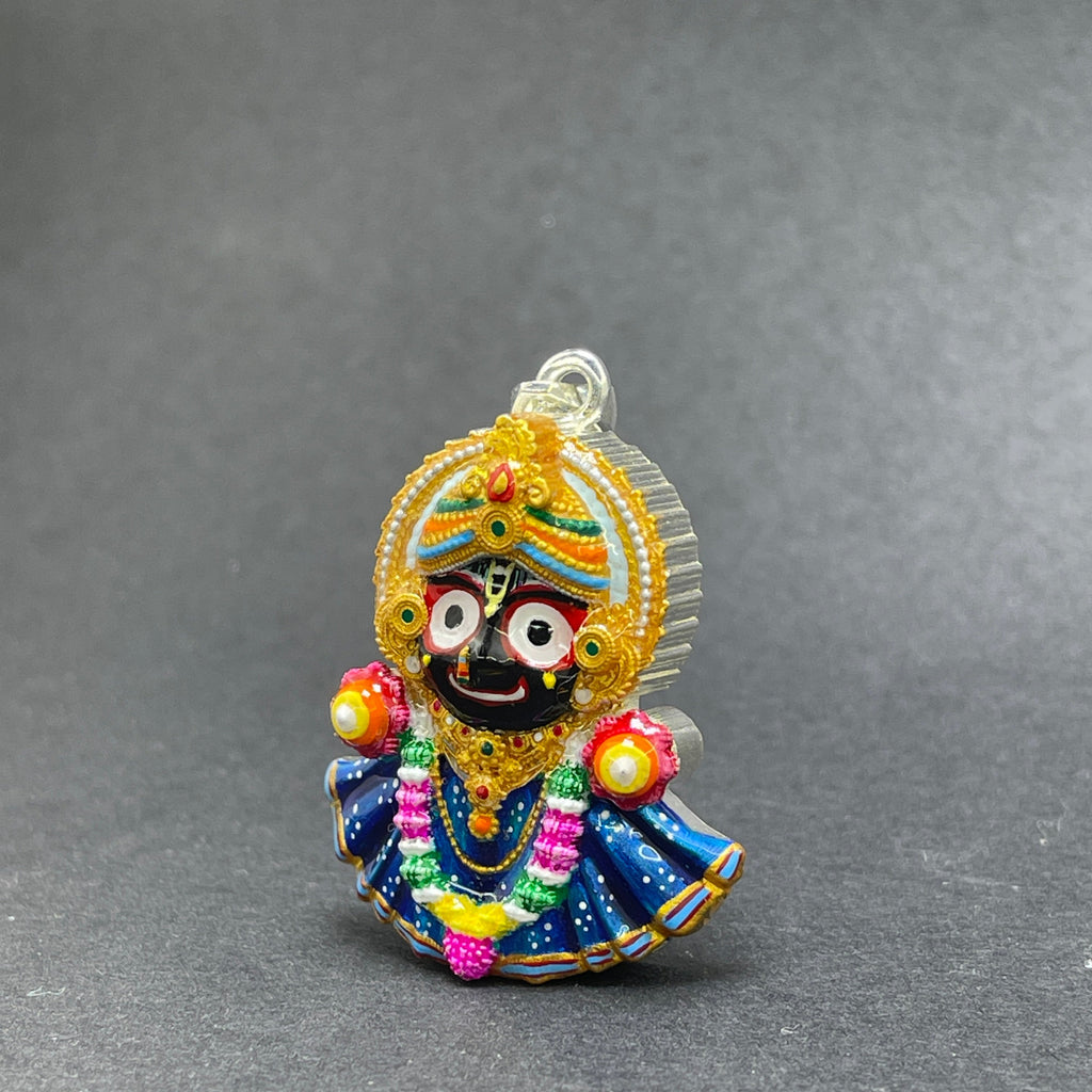 The 925 silver Jagannath devotional pendant showcasing its colorful enamel against a neutral background.