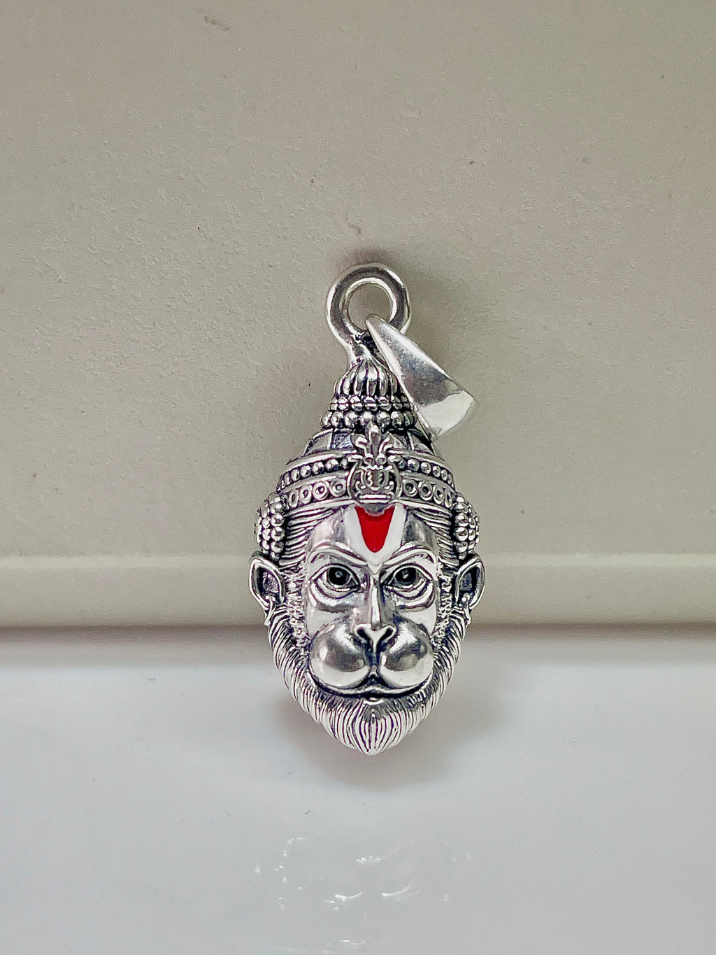 Close-up detail of the 925 sterling silver Hanumanji pendant highlighting the antique oxidised finish on the face.