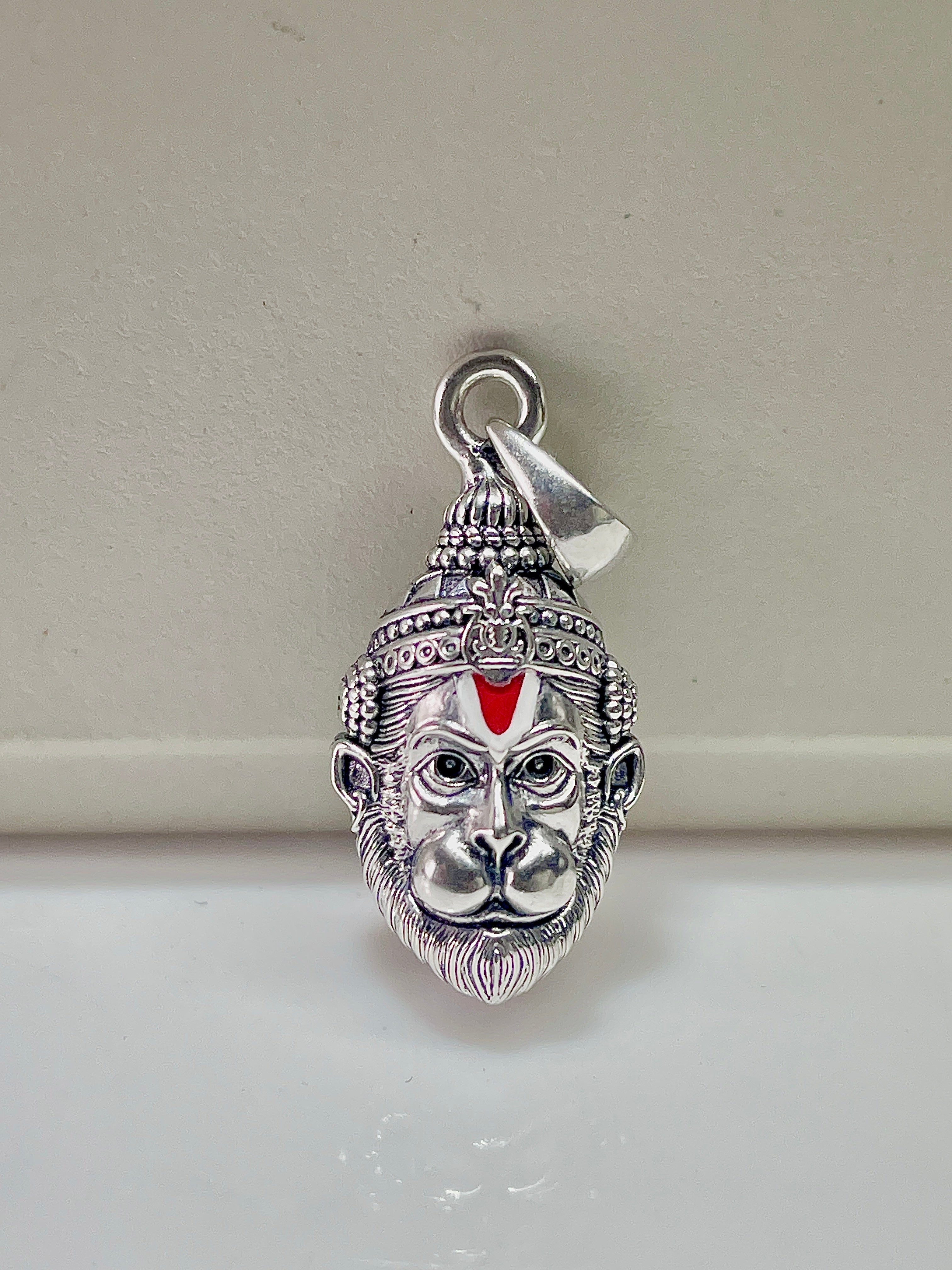 Close-up detail of the 925 sterling silver Hanumanji pendant highlighting the antique oxidised finish on the face.