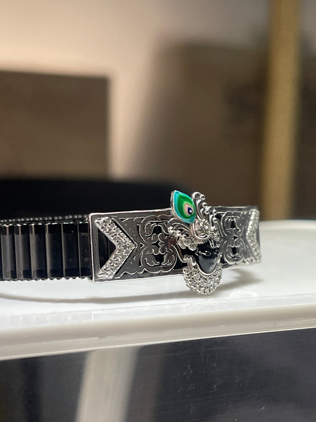 Close-up detail of the Shrinathji face on the 925 silver bracelet, showcasing the intricate Meena enamel artistry.