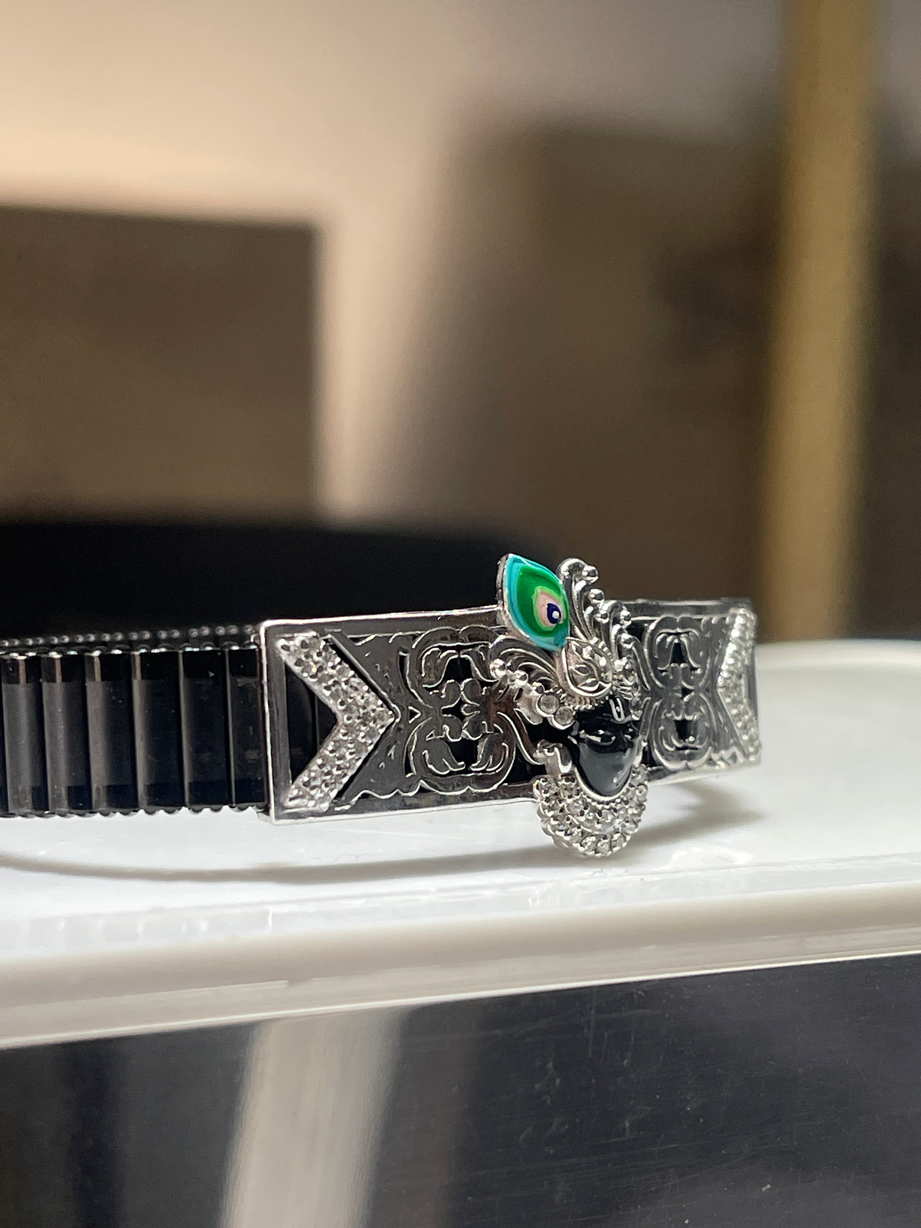 Close-up detail of the Shrinathji face on the 925 silver bracelet, showcasing the intricate Meena enamel artistry.