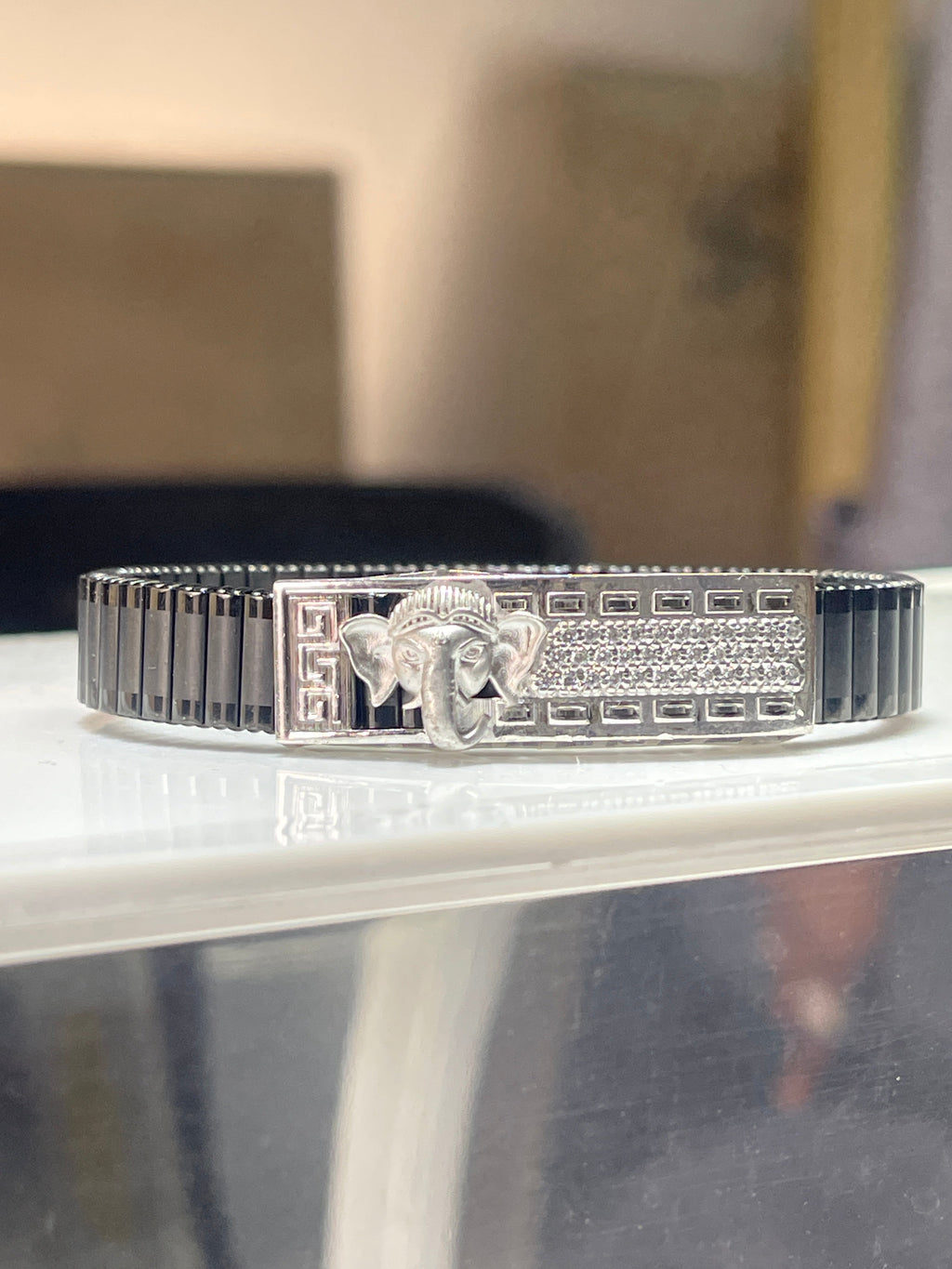 Front view of the Lord Ganesha bracelet for men, showcasing the detailed Ganpati design in 925 silver on a black kada.