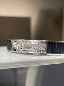 Side profile of the 925 silver Lord Ganesha bracelet for men, displaying the sleek black stainless steel spring belt.
