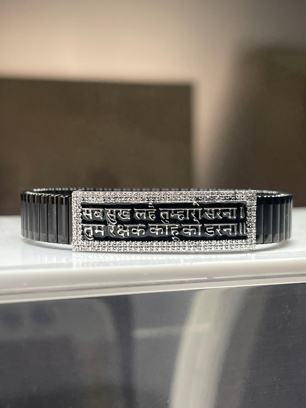 A 925 silver Hanuman Chalisa bracelet for men with a black kada strap, displayed on a neutral background.