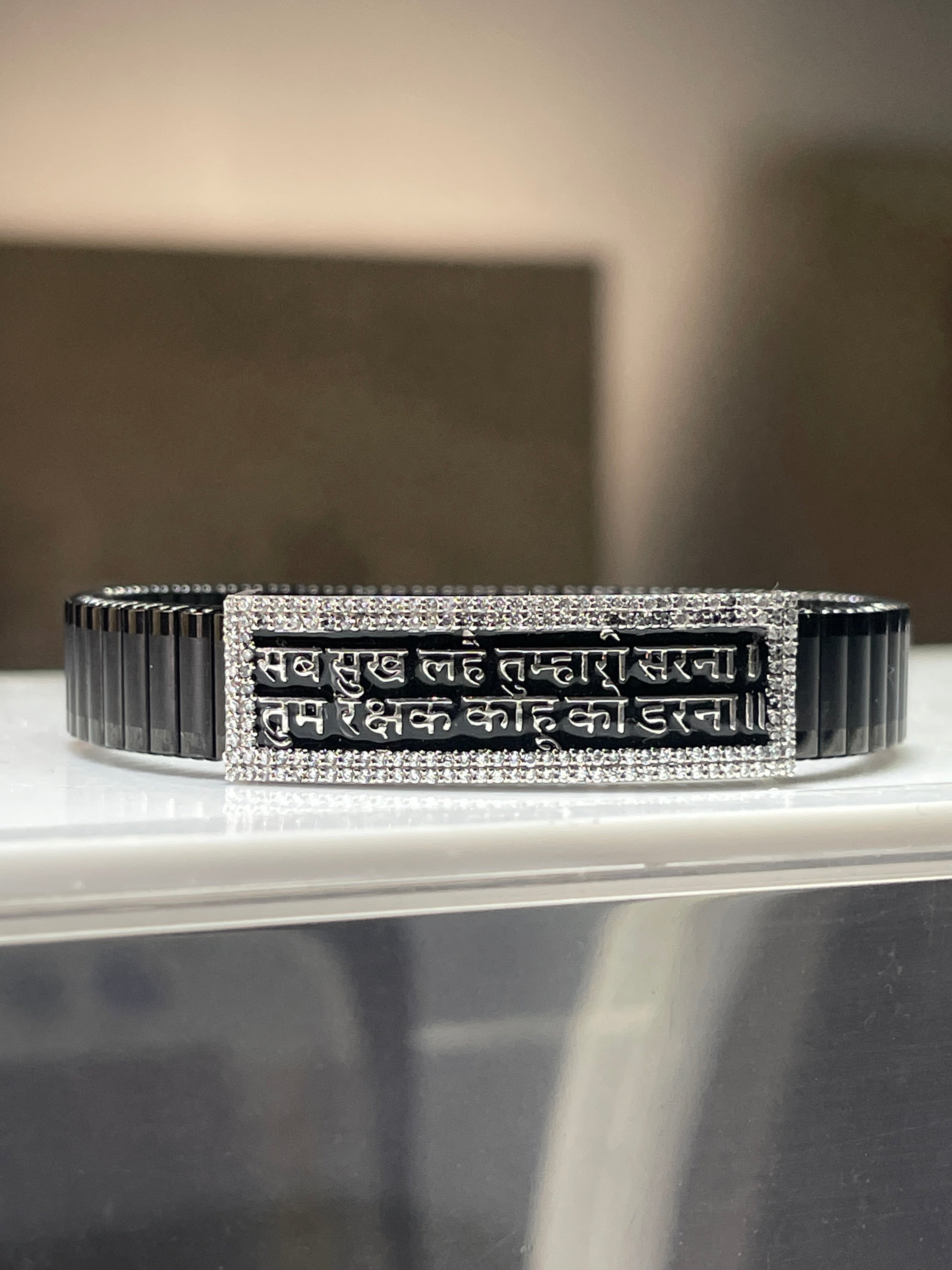 A 925 silver Hanuman Chalisa bracelet for men with a black kada strap, displayed on a neutral background.