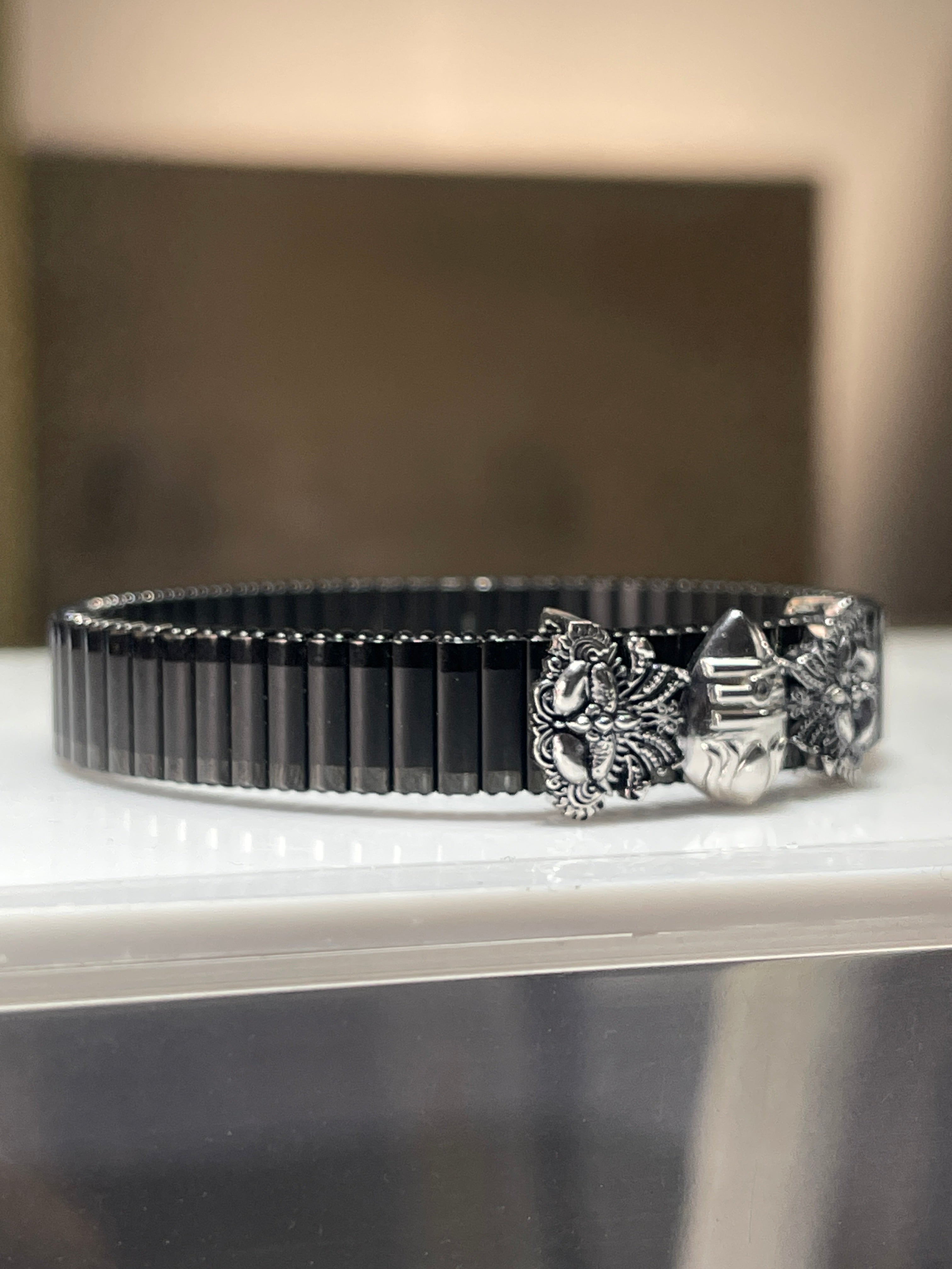 Close-up detail of the spiritual Murugan Vel bracelet, highlighting the craftsmanship of the silver-plated Kartikeya spear.