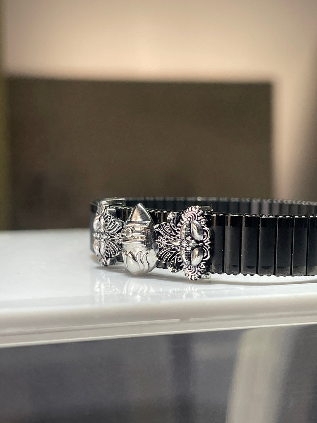 Side profile of the Lord Kartikeya kada for men, showing the sleek adjustable black strap and silver-plated Murugan Vel