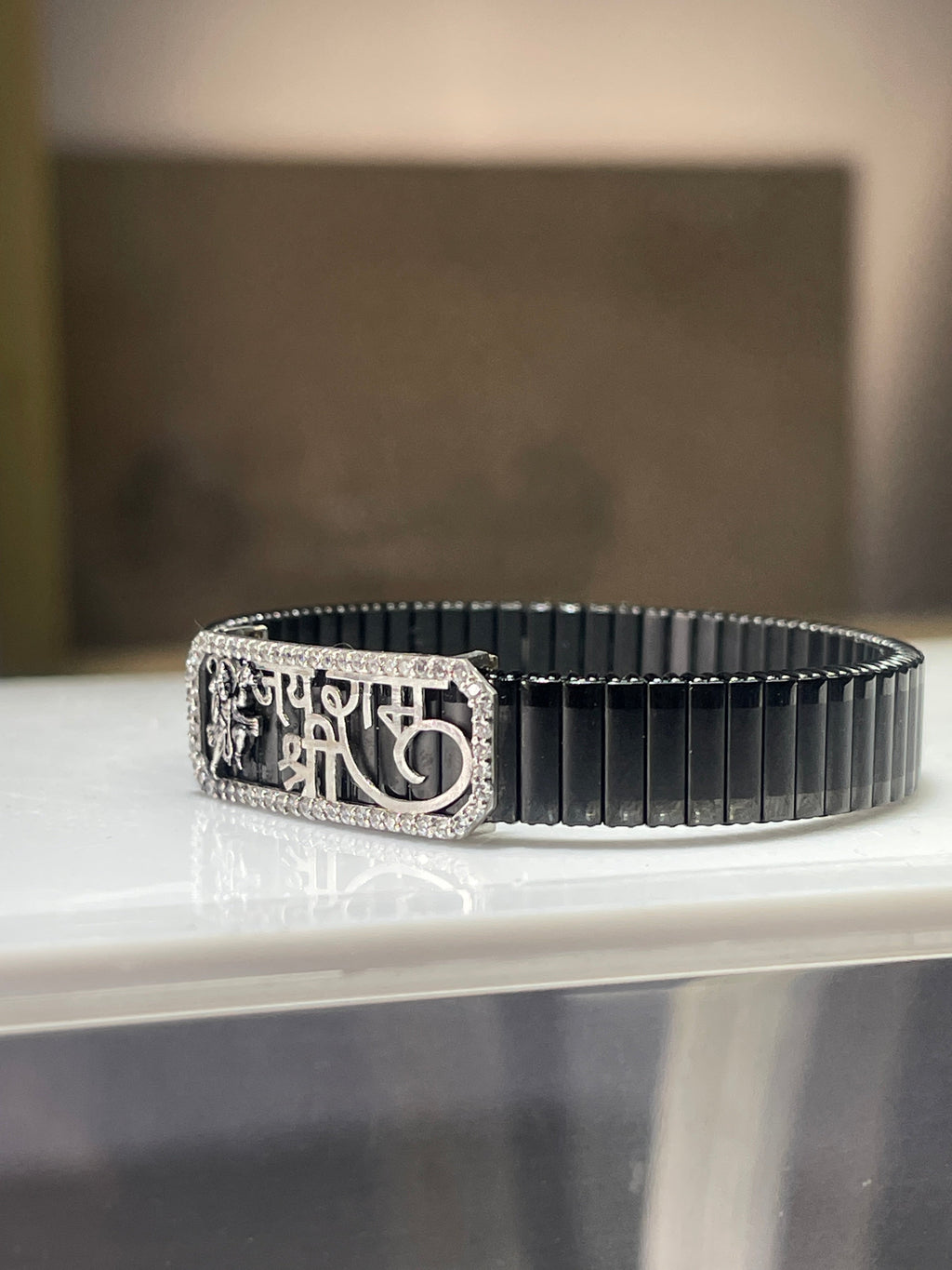 Side profile of the 925 Silver Hanuman Ji Bracelet showing the flexible and adjustable stainless steel spring strap.
