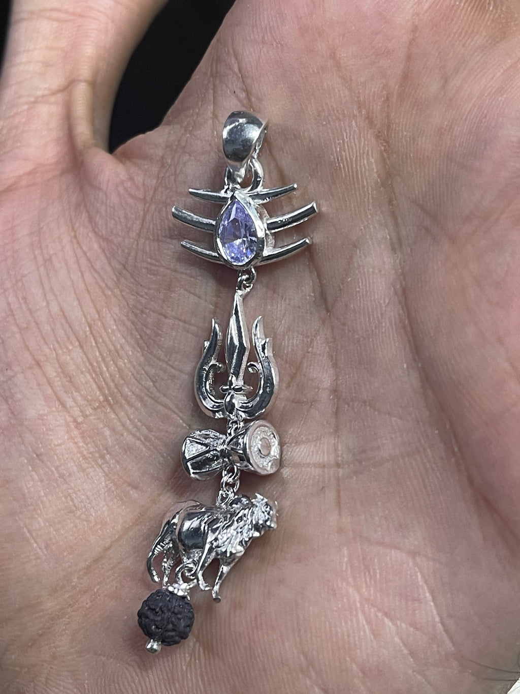 Side profile of the sterling silver Lord Shiva pendant, highlighting its high-polish finish and detailed design.