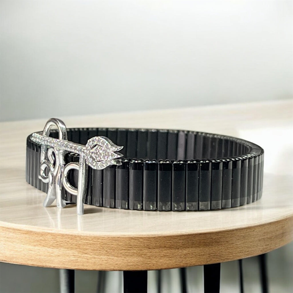 Close-up detail of the sterling silver Shiv lettering and strong black stainless steel strap.