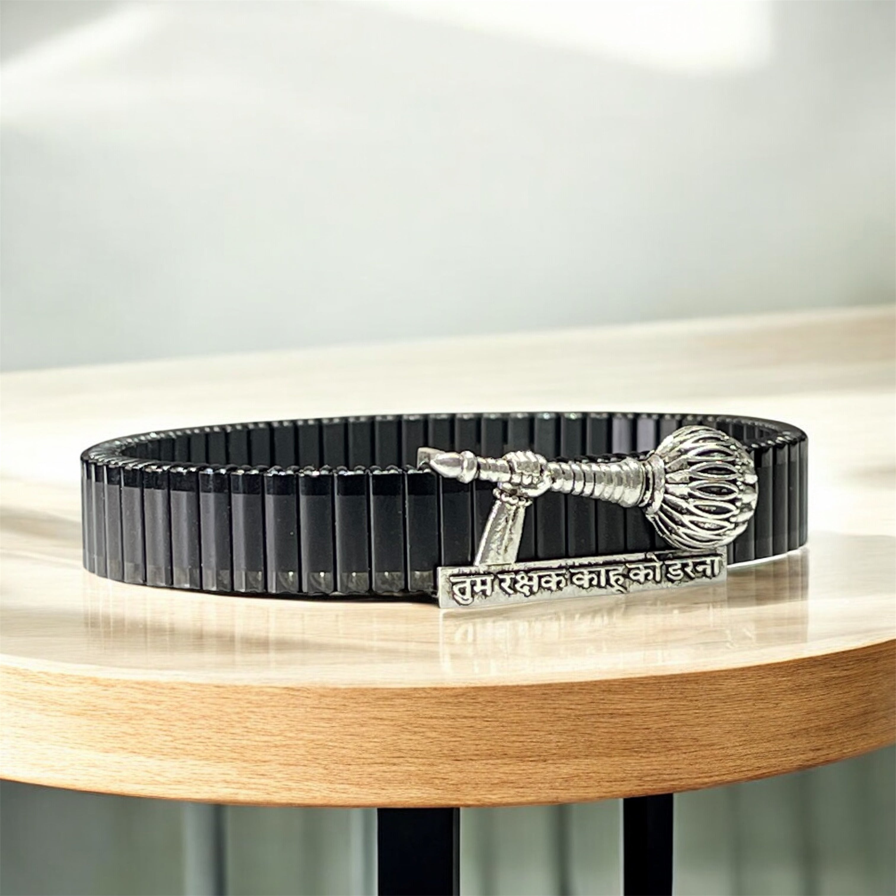 Side profile of the unisex 925 silver Hanuman Gada bracelet highlighting the secure black link strap.