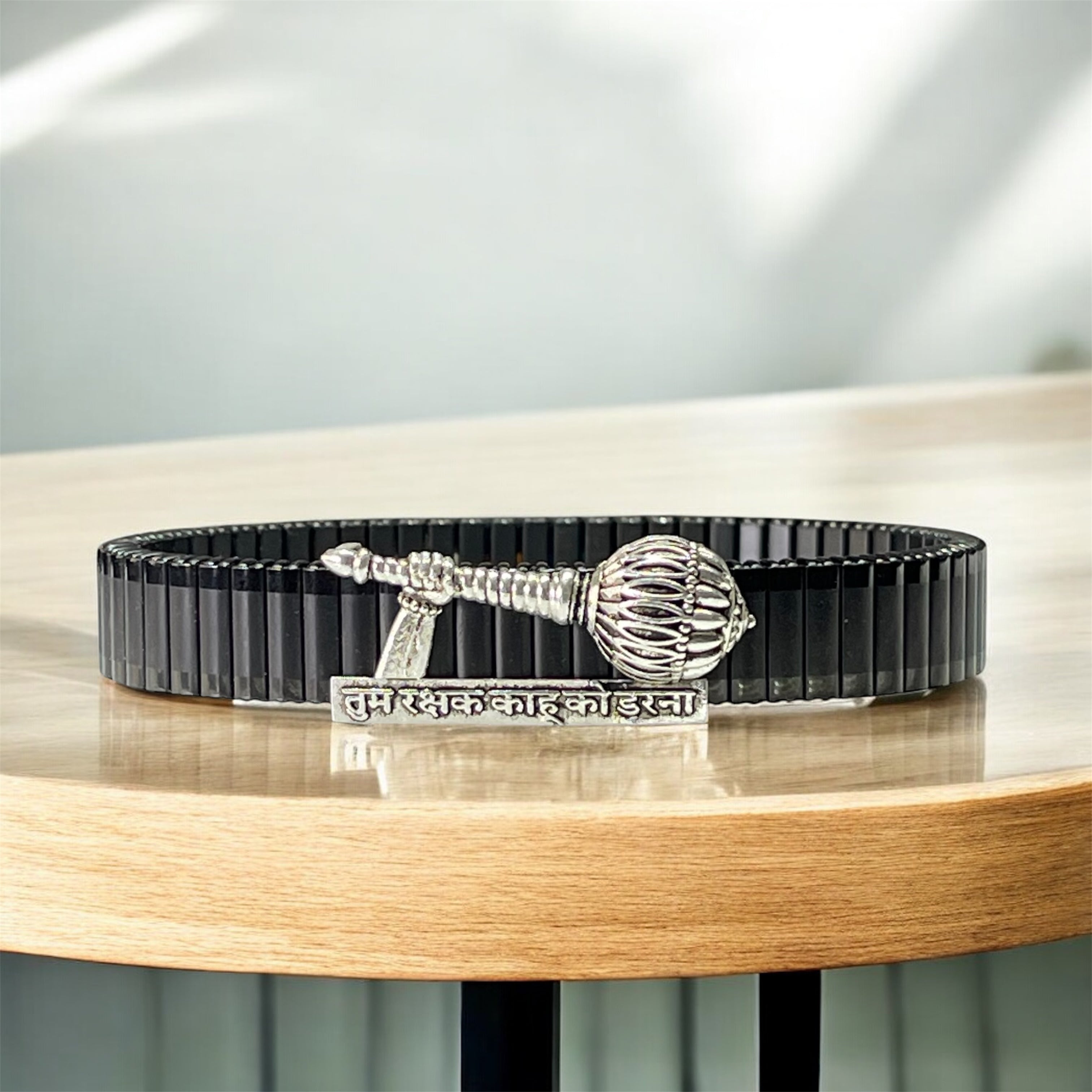 Front view of the 925 Silver Hanuman Gada Bracelet featuring an engraved mantra on a black steel strap.