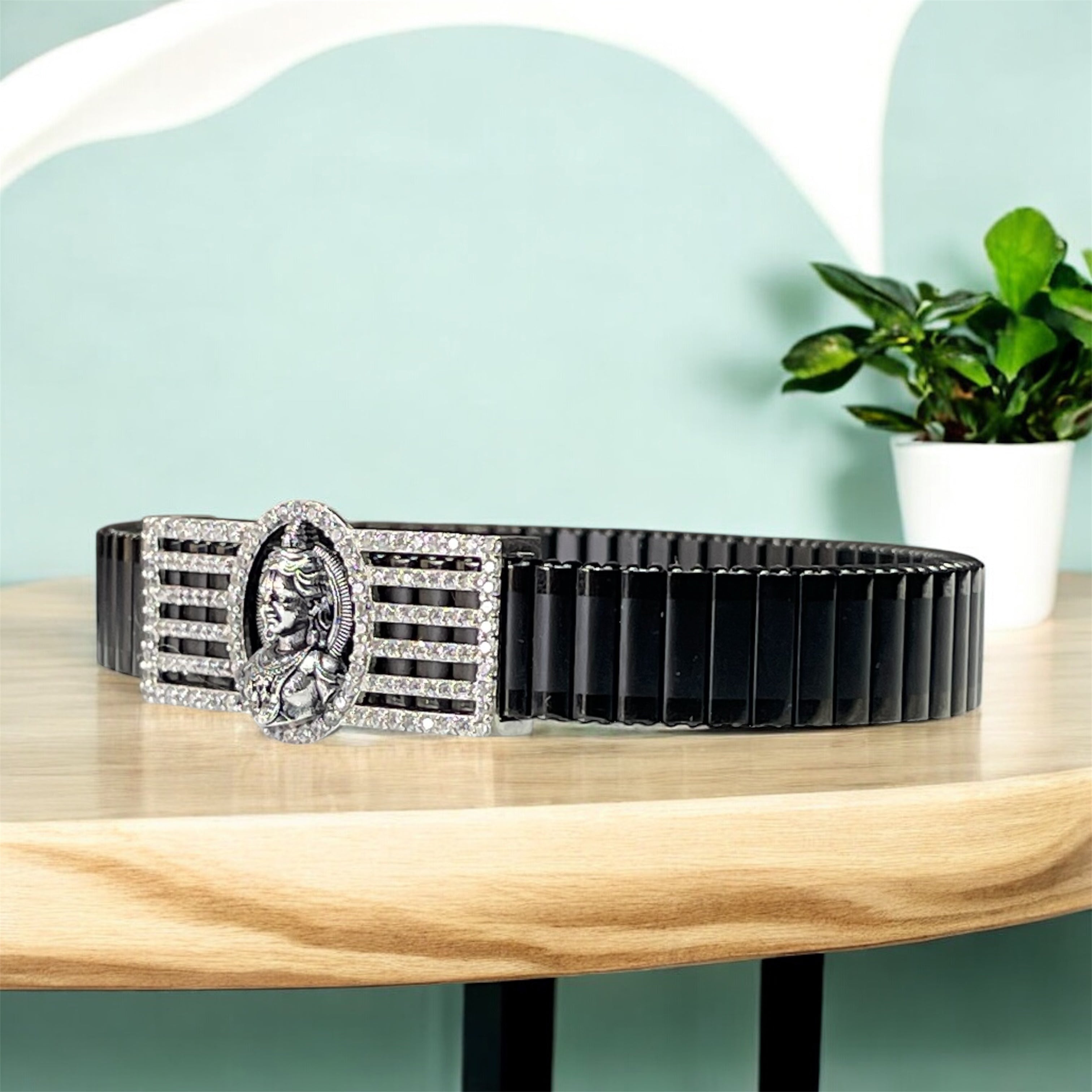 Close-up detail of the intricately carved Lord Ram Lalla motif in 925 sterling silver with pave stones.