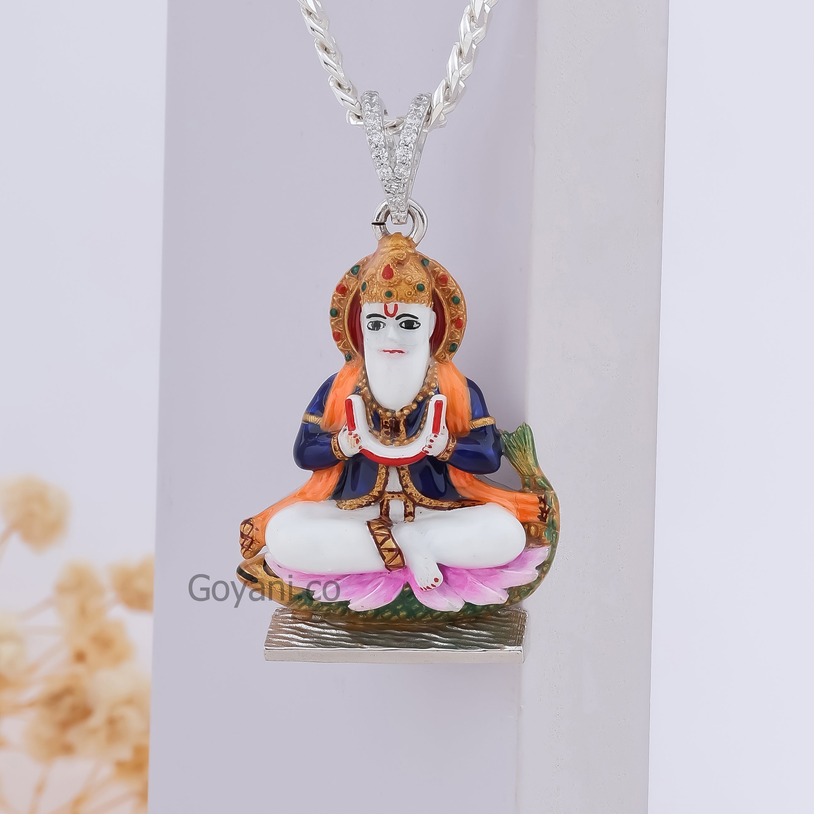 A close-up of the Jhulelal 925 Silver Pendant, highlighting the vibrant enamel colors and sparkling diamonds.