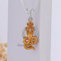 A close-up of the Gogaji Maharaj silver pendant highlighting the vibrant colors of the traditional Mina craftsmanship.