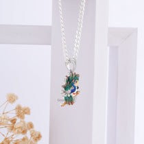 Angled view of the Krishna with Peacock Enamel Pendant in 925 silver, showcasing its lustrous finish and design.