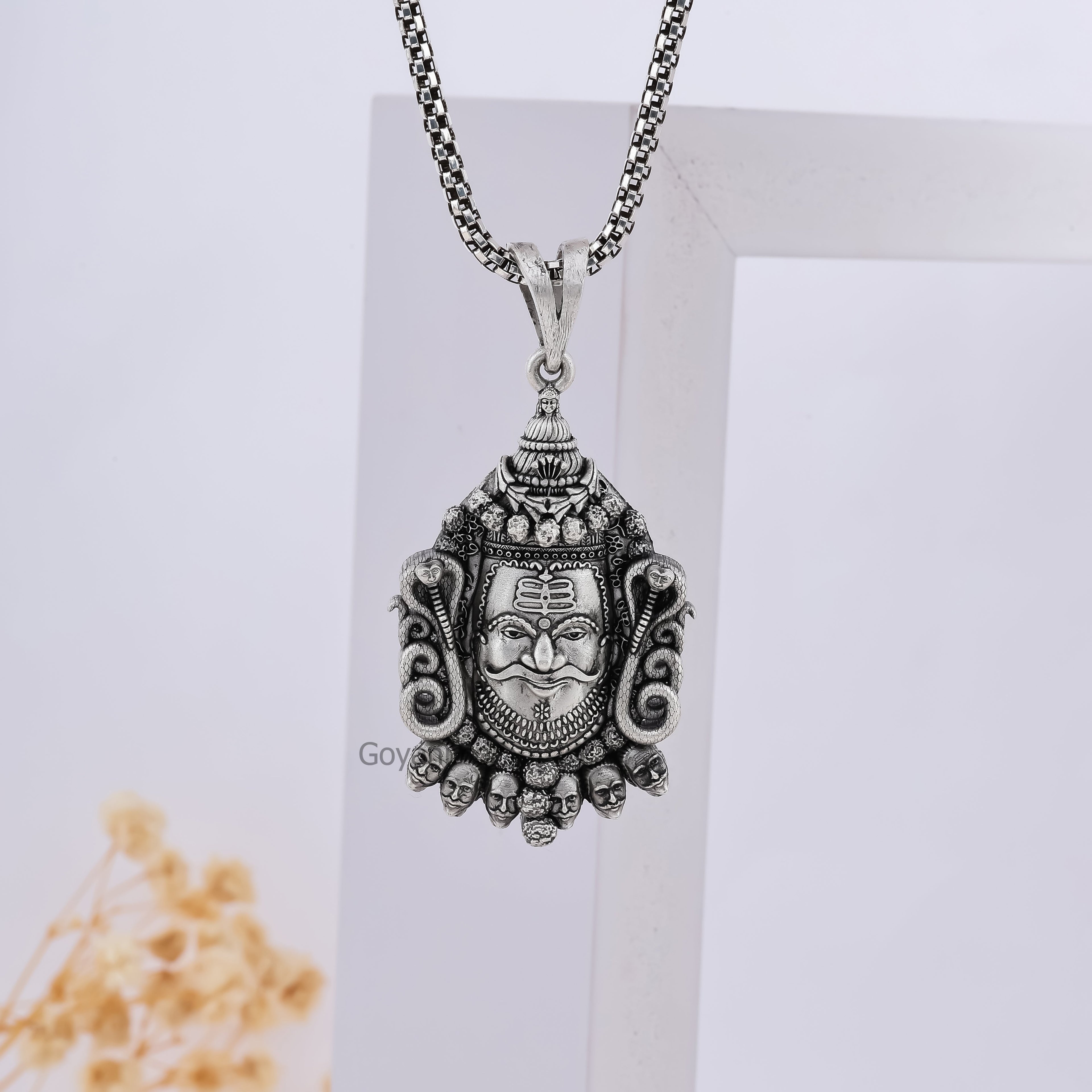 The Ujjain Mahakaleshwar Silver Mahakal Pendant held in hand to display its authentic 925 sterling silver quality.
