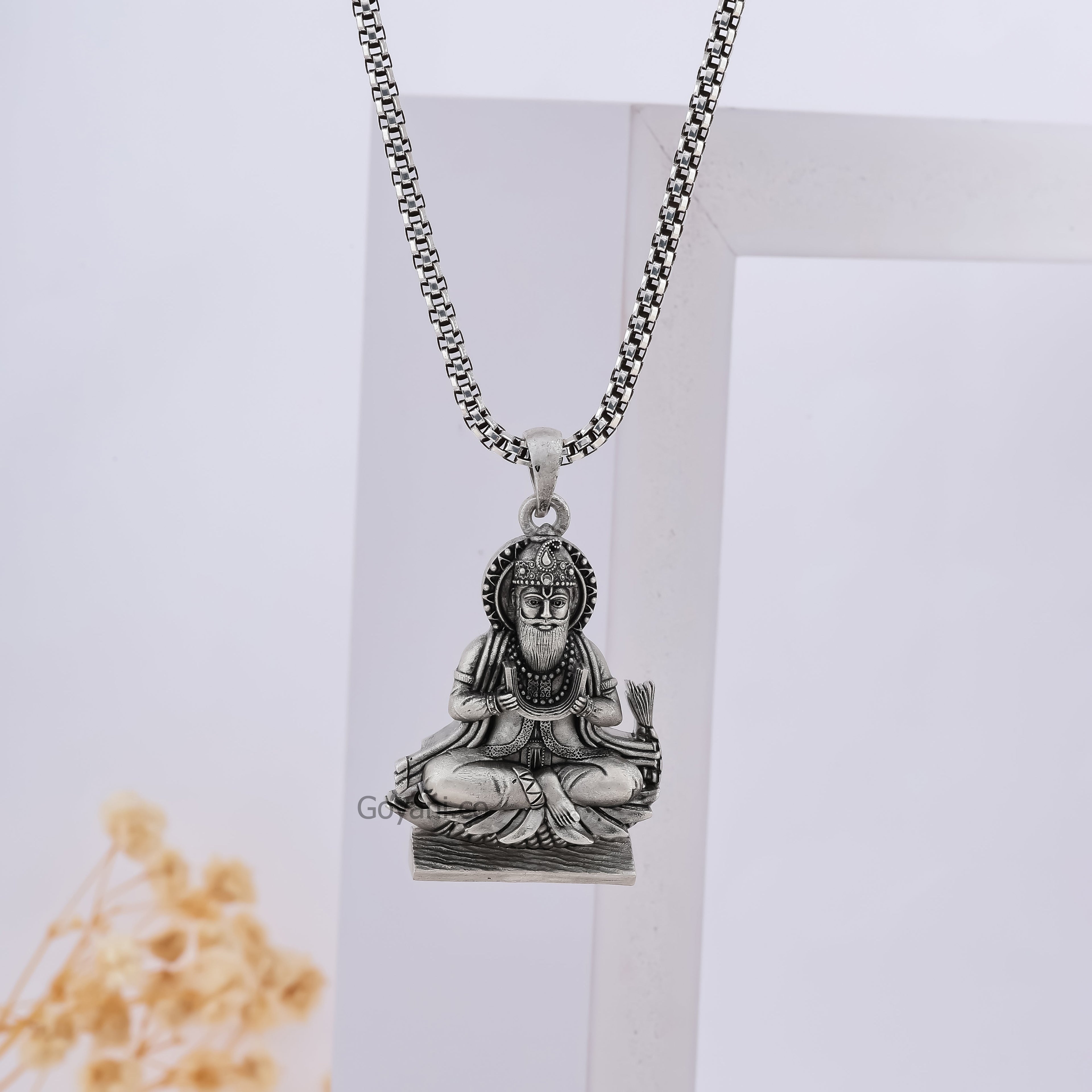 A model wearing the Alankar 925 sterling silver Jhulelal pendant to show its size and how it looks when worn daily.