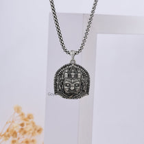 The sterling silver Kaal Bhairav pendant paired with a chain to illustrate how it looks when worn as a devotional necklace.