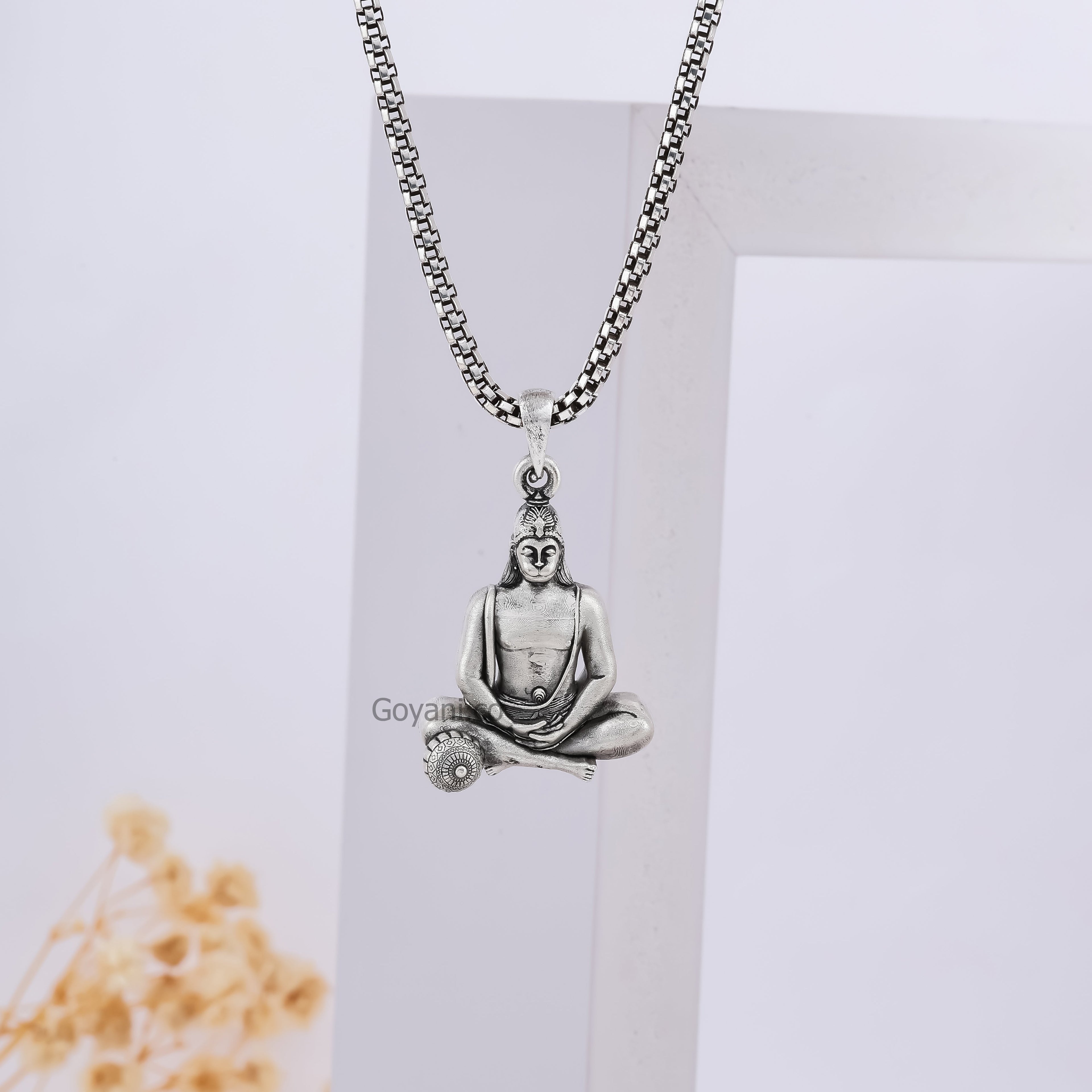 Lifestyle image of the Silver Moraribapu Meditating Hanumanji Pendant worn to show its size and elegant style.