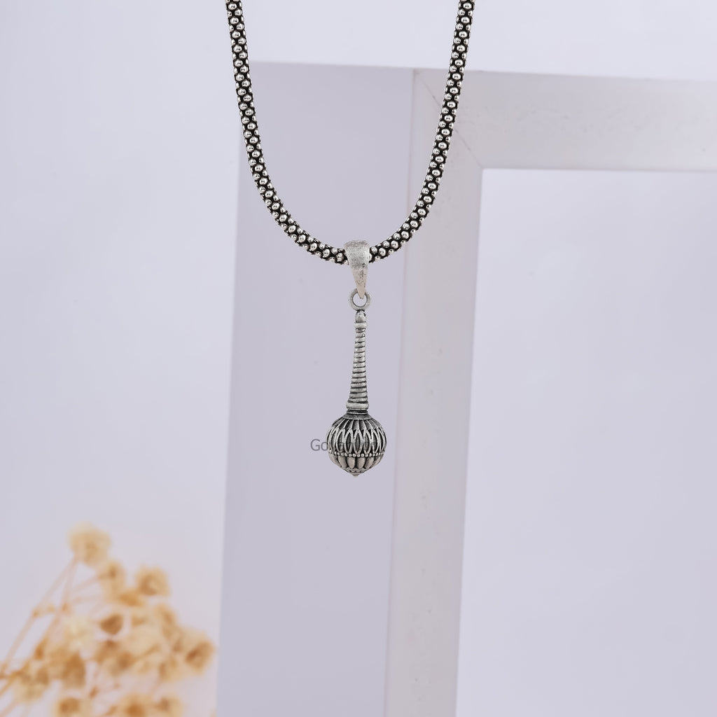 A person wearing the 925 sterling Silver Gada Pendant, demonstrating its size and how it hangs as a symbol of divine