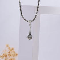 A person wearing the 925 sterling Silver Gada Pendant, demonstrating its size and how it hangs as a symbol of divine