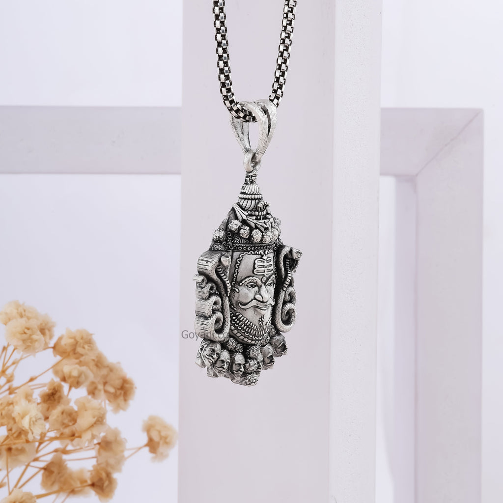 A model wearing the oxidized Silver Mahakal Pendant to show its size and how it looks as a devotional locket.