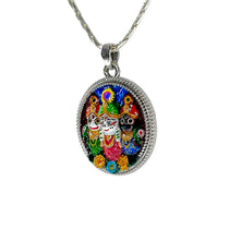 Angled view of the 925 silver Puri Jagannath Divine Trinity pendant for men and women.
