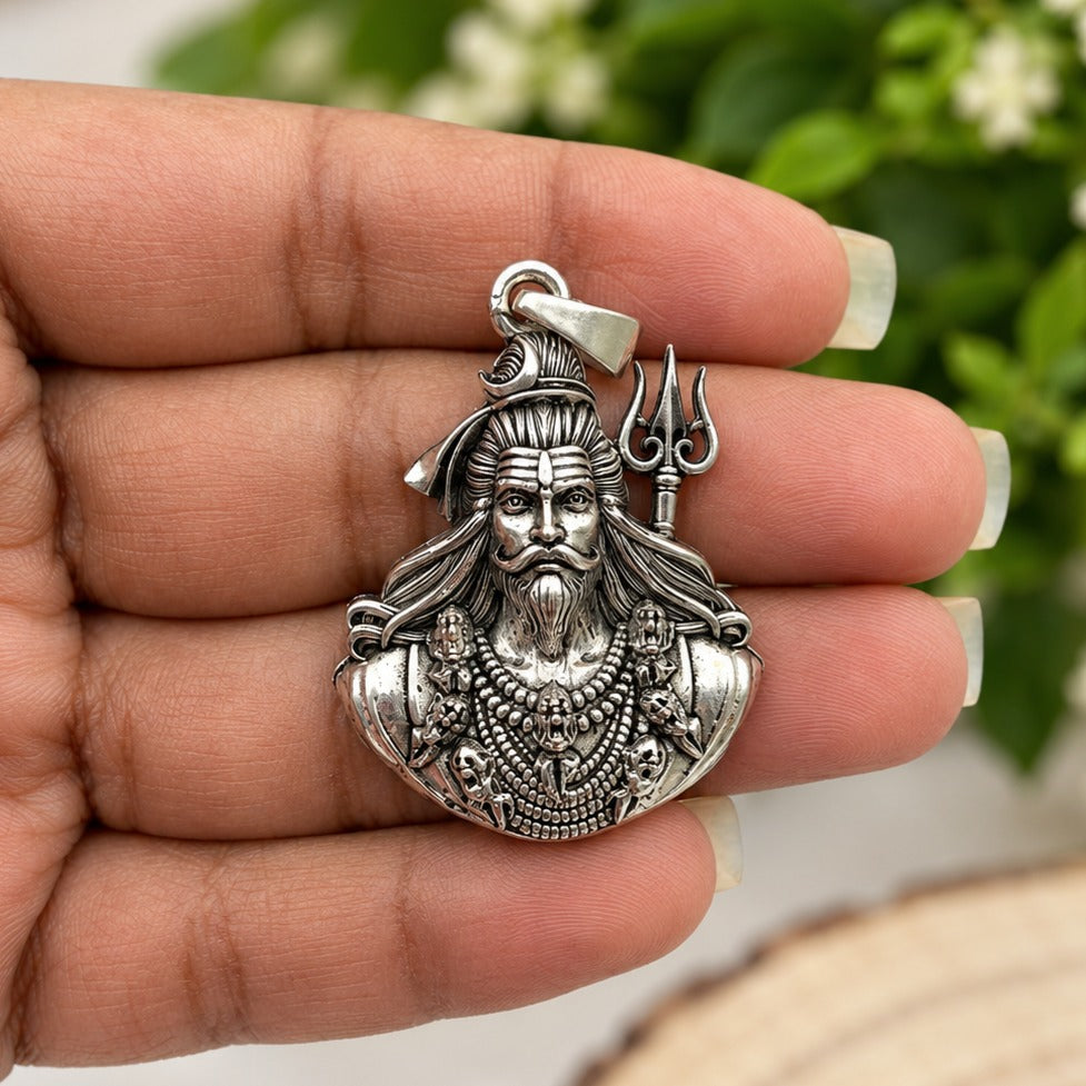Intricate Silver Shiva Pendant in Hand-crop.jpg