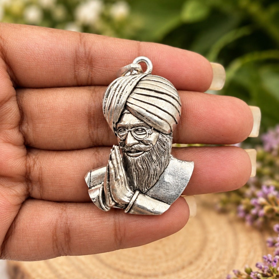 Silver Turbaned Saint Pendant in Hand-crop.jpg