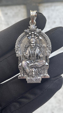 The sterling silver Mariamman locket shown for scale, a perfect divine amulet for temple visits and protection.