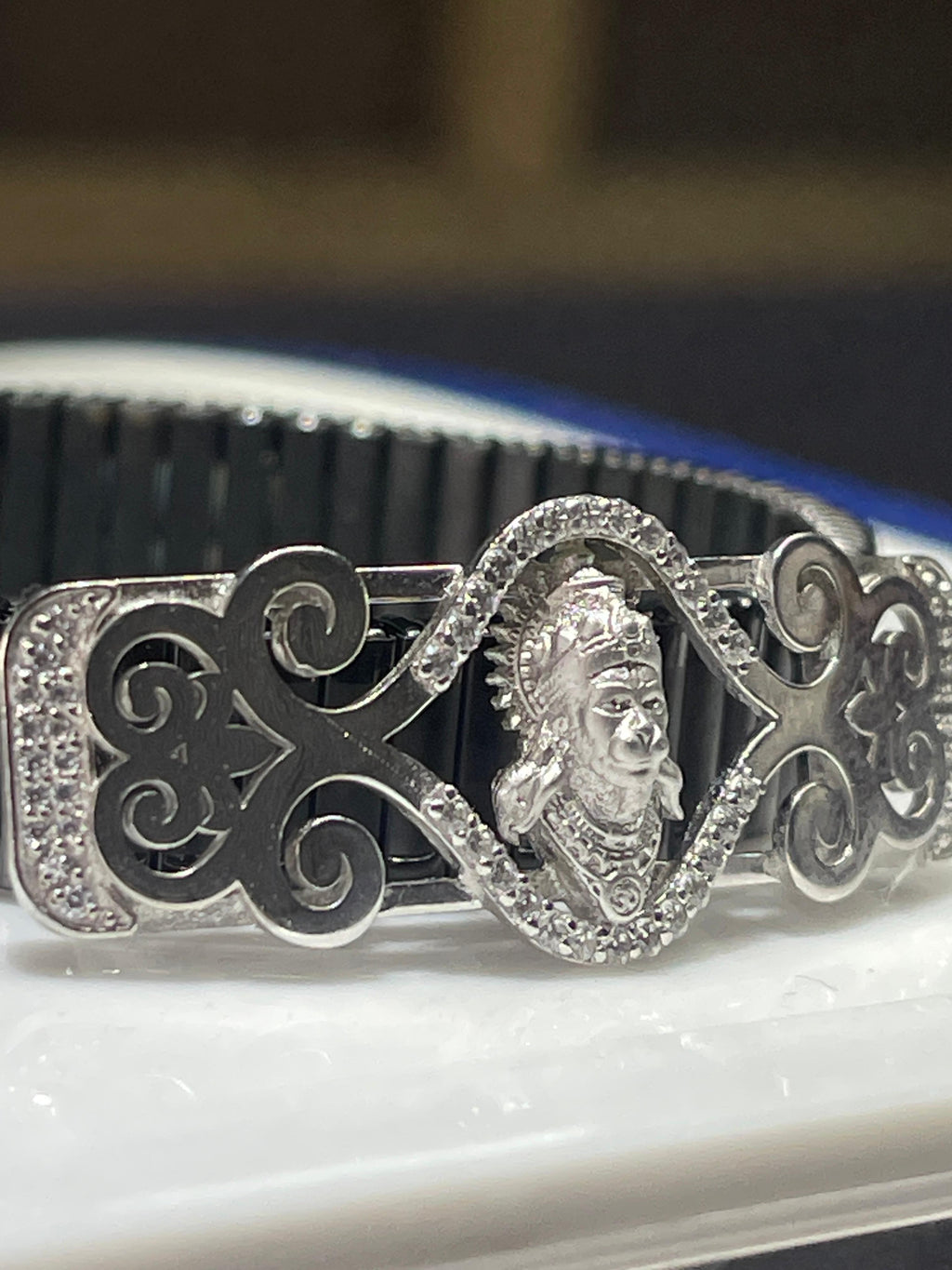 A 925 silver Hanumanji bracelet with diamonds worn on a wrist to display its elegant size and fit for daily wear.