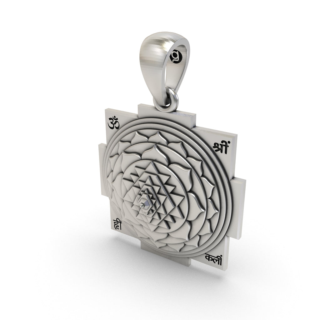 Angled view of the silver Shri Yantra spiritual pendant representing wealth and protection.